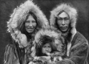A family photo of an Inupiat Eskimo mother, father, and son, photographed in Noatak, Alaska, by Edward Sheriff Curtis circa 1929. The scan was made from a black and white film copy negative.